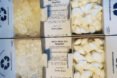 open cardboard boxes filled with laundry pods and dishwasher pods
