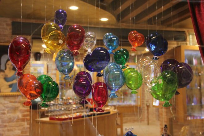 delicate glass-blown balloons hanging on strings in a shop