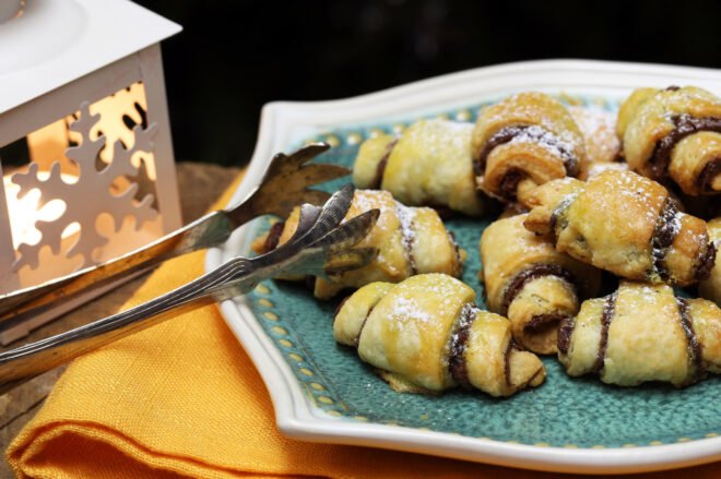 rugelach on a plate near a lantern