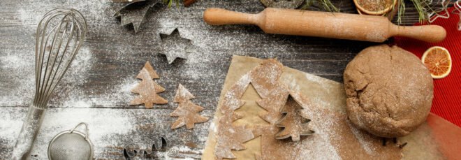 flat lay of vegan gingerbread dough, rolling pin, and cookie cutters