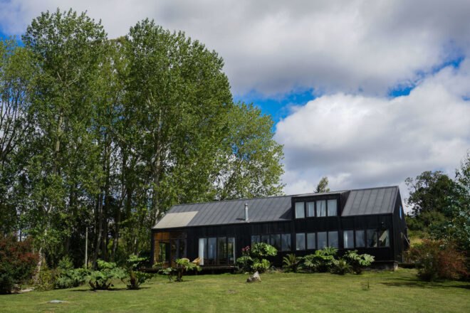 long black home with several windows and large backyard