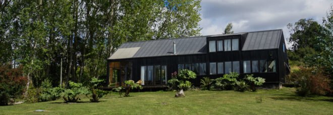 long black home with several windows and large backyard