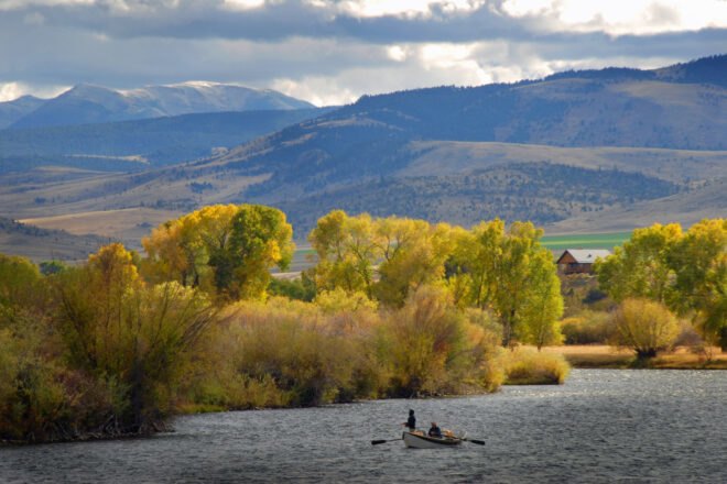 people in boat on lake fly-fishing