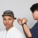 designer tightening a hat on a model
