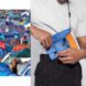 person latching blue crossbody bag