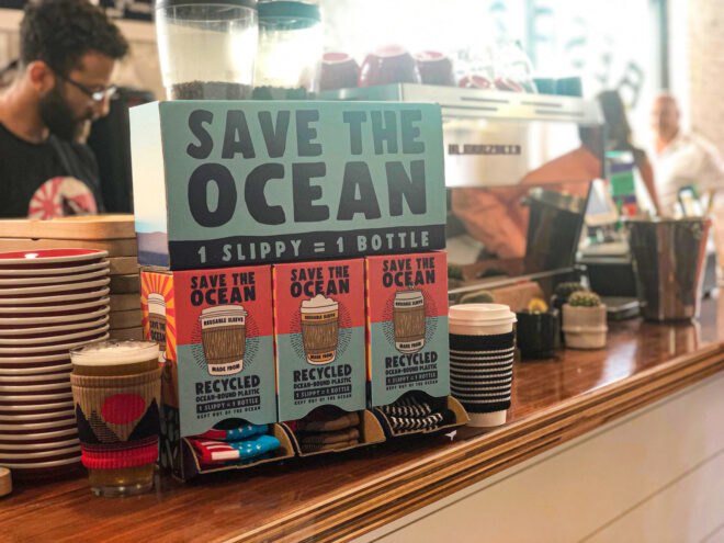 cardboard box filled with reusable cloth coffee sleeves