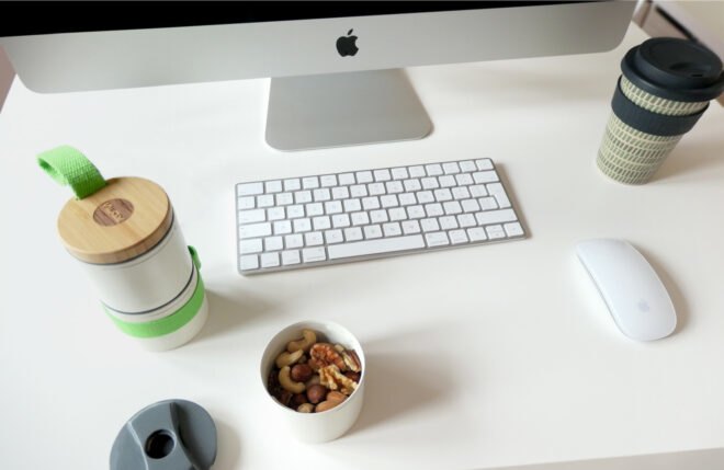 small white, round containers near a computer