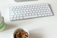 small white, round containers near a computer