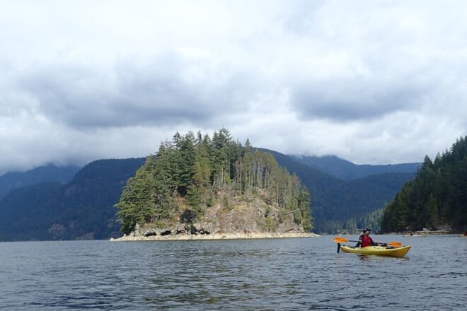 person kayaking in Capilano River