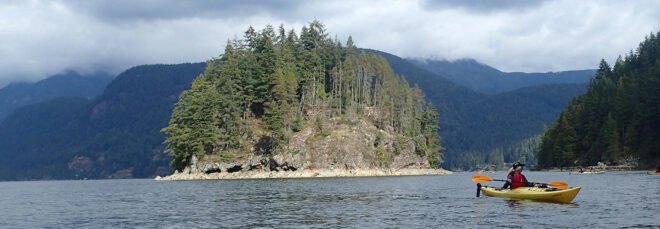 person kayaking in Capilano River