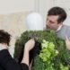 two people outfitting a mannequin with a garden vest
