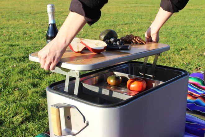 person lifting lid to a steel cooler
