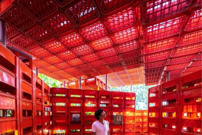 person inside plastic crate pavilion
