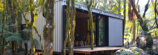 outdoor view of tiny cubed cabin with outdoor deck