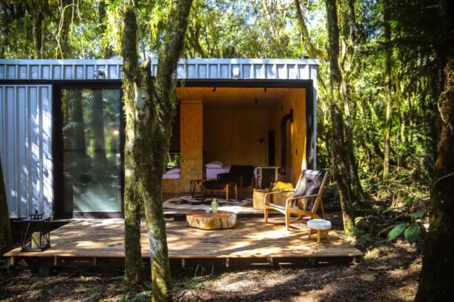 tiny cabin with large sliding door leading out to wooden deck