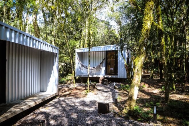 set of two cabins in the woods