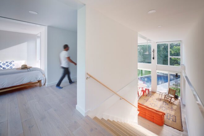 wide staircase leading from living room up to a bedroom