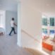 wide staircase leading from living room up to a bedroom