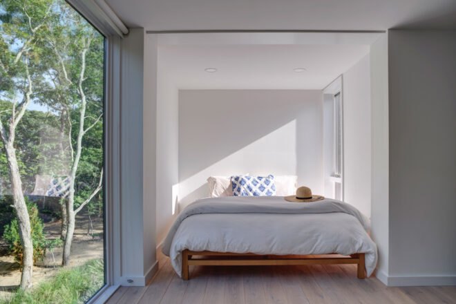 white bedroom with a glass wall