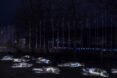 several body-shaped plastic sculptures outside at night