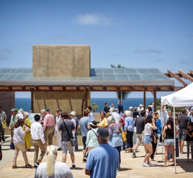 crowd of people near building with solar panels