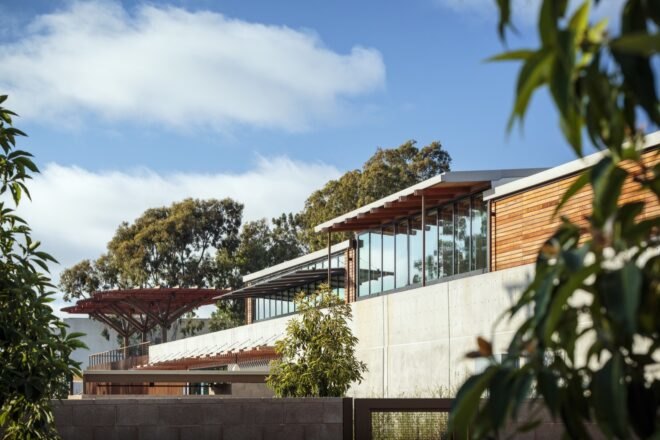 glass and wood building with slightly slanted roofs