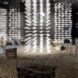 rendering of dark room with people looking at art