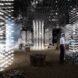 rendering of dark room with people looking at art