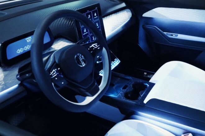 close-up of a steering wheel and digital dashboard