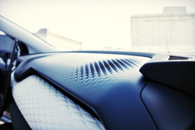 close-up of perforated air vents on a car dashboard