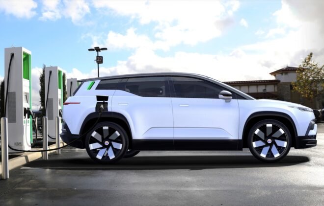 white SUV plugged into charging station