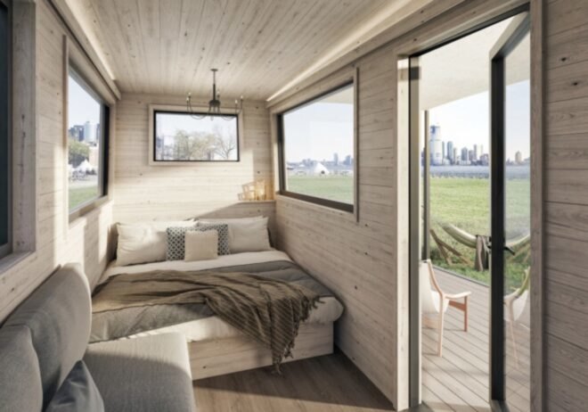 light wood-lined tiny home with large white bed