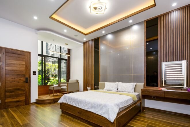 white bed on wood platform in large white room