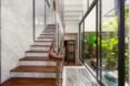 open glass wall beside a wood and marble staircase