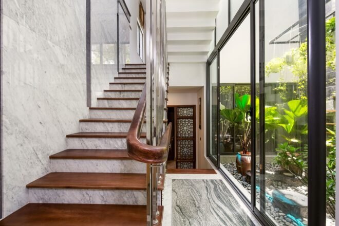open glass wall beside a wood and marble staircase