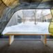 wood bench near pavilion opening revealing snowy views