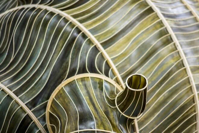 curving pavilion made of rattan and kelp