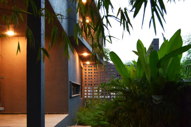 concrete home tucked into greenery
