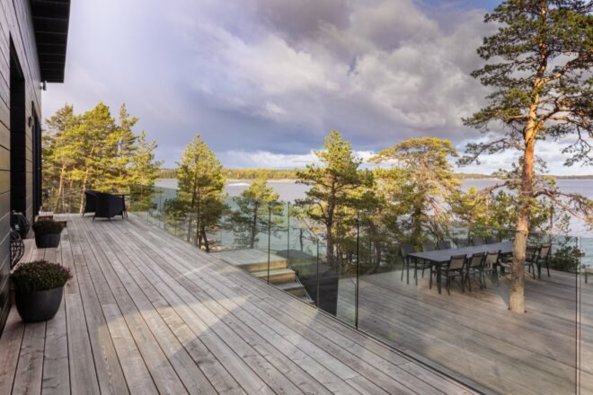 a patio looking off at a body of water and forest