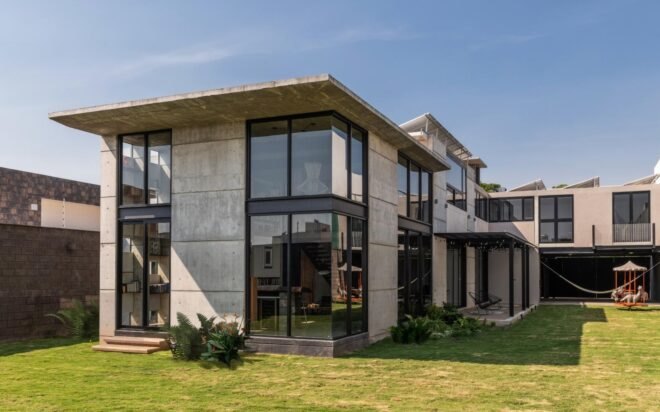 flat roofed home with several windows
