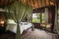 large white bed with mosquito netting