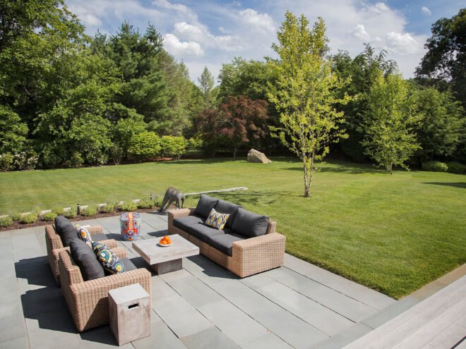 an outdoor sitting area surrounded by green lawn