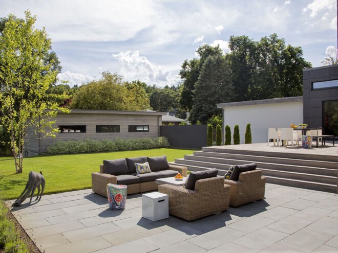 an outdoor sitting area surrounded by green lawn