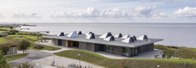 long, one-story gray building near the sea