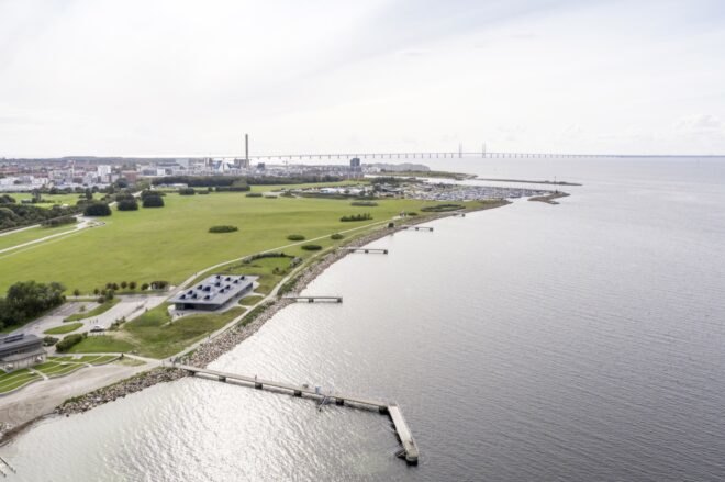 aerial image of gray building near pier and the sea