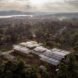 aerial view of brick building with wavy, solar-powered roof