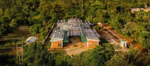 tan brick building covered in solar panels