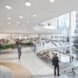 rendering of people walking on curving platforms with glass walls