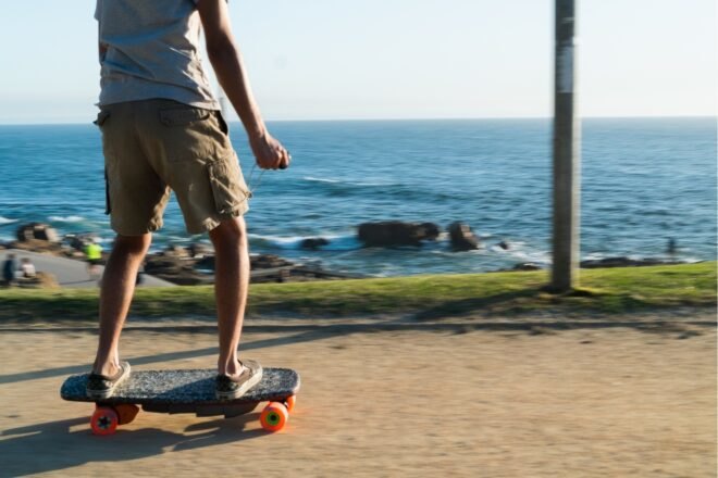 person on skateboard near the water
