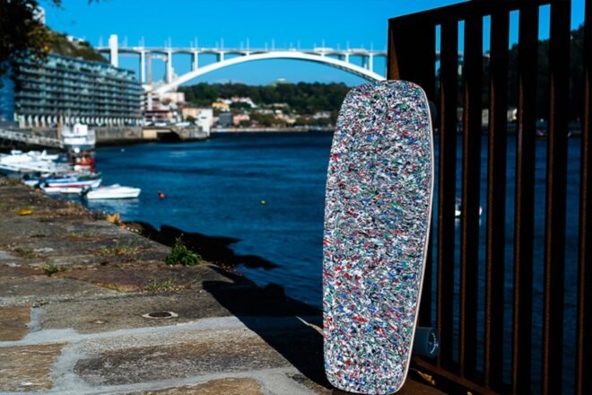 speckled skateboard leaning on pole